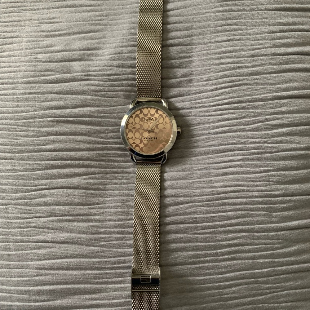 Silver Coach watch with soft pink face.